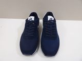 a pair of blue sneakers sitting on top of a white table