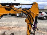 a yellow excavator that is sitting in the dirt
