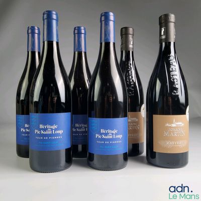 several bottles of wine are lined up on a table