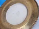 a picture of a gold plate with a blue background