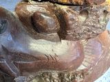 a statue of a frog with a tag on it ' s neck