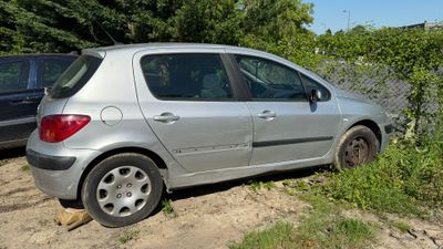 a silver car that is parked on the side of the road