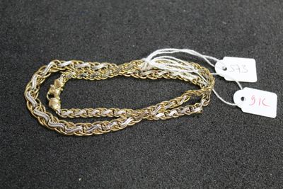 a close up of a gold chain with a tag on it