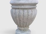 a stone vase that is sitting on a white surface