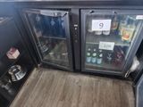 a refrigerator with drinks inside of it in a kitchen