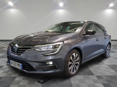 a grey car is parked in a room with a checkered floor