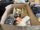 a cardboard box full of books and other items