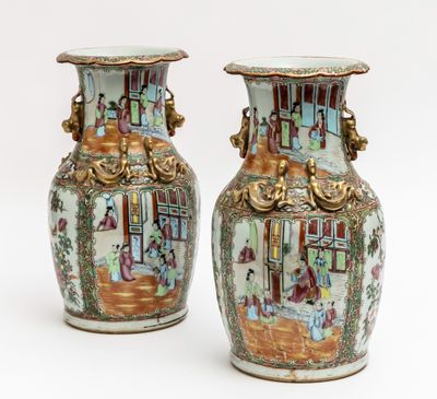 pair of chinese vases with figures on them on a white background