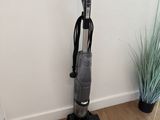 an image of a vacuum cleaner in the corner of a room