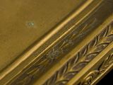 a close up of a gold plate on a black background