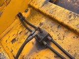 a yellow bulldozer that is sitting in the dirt