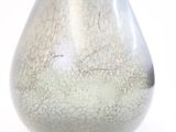 a silver vase that is sitting on a table