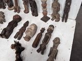 a lot of wooden figurines that are on a table