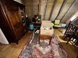 a living room with a couch and a rug on the floor