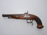 an old gun that is on display on a white surface