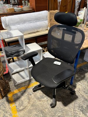 une chaise de bureau noire avec une assise noire dans une pièce