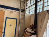 a room that has a ladder and boxes in it