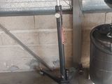 a picture of a large metal drum and a small black bucket