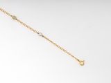 a close up of a gold chain bracelet on a white background