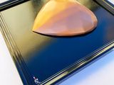 a picture of a piece of cake on a black tray