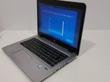 a laptop computer sitting on a table with a blue screen