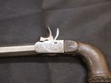 an old gun that is on display on a black cloth