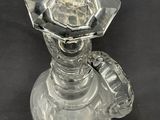 a clear glass candle holder on a black table