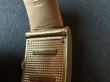 an image of a gold wrist watch with a leather band