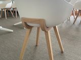 a white chair with wooden legs and a white chair with a white seat