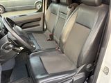 the interior of a car with the door open and the driver ' s seat down