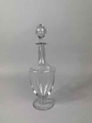 clear glass decanter with a silver ball on the top