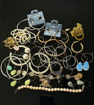a black table topped with lots of jewelry on top of it