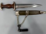 un couteau et une chaîne accrochés au mur