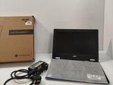 a laptop computer sitting on top of a desk next to a box