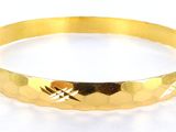 an image of a close up of a gold bracelet on a white background