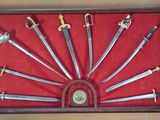 a lot of swords in a display case on the wall