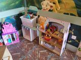 a room with a doll house and a doll house on the floor