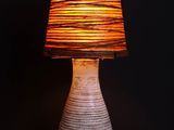 a lamp that is on a table with a black background