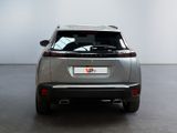 the rear end of a silver suv parked in a white room