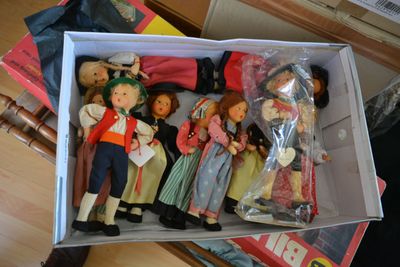 a box full of dolls sitting on top of a table