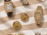 an assortment of gold and silver jewelry including a watch, bracelets, rings, and rings