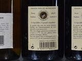 two bottles of wine sitting on top of a table next to each other