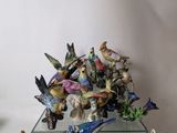 a glass table with a bunch of figurines on top of it