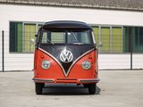 a red and black vw bus parked in front of a building