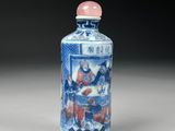 a small blue and white bottle with a picture on it