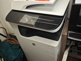 a printer sitting on top of a printer next to a printer
