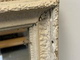 a close up of a mirror with peeling paint on it