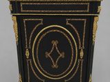 a black and gold cabinet with a clock on top