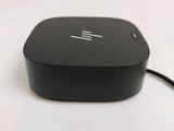 a black apple tv box sitting on a white surface
