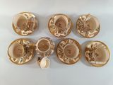 six cups and saucers sitting on a white table